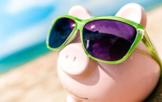 Piggy bank in sunglasses showing the hidden costs of cheap IT support services.