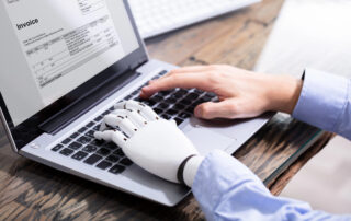 Employee using laptop with AI assistance, highlighting hidden workplace AI use and productivity support.