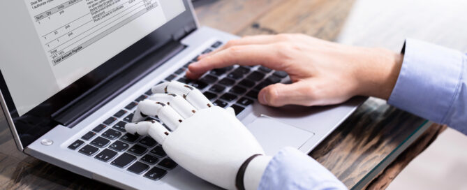 Employee using laptop with AI assistance, highlighting hidden workplace AI use and productivity support.